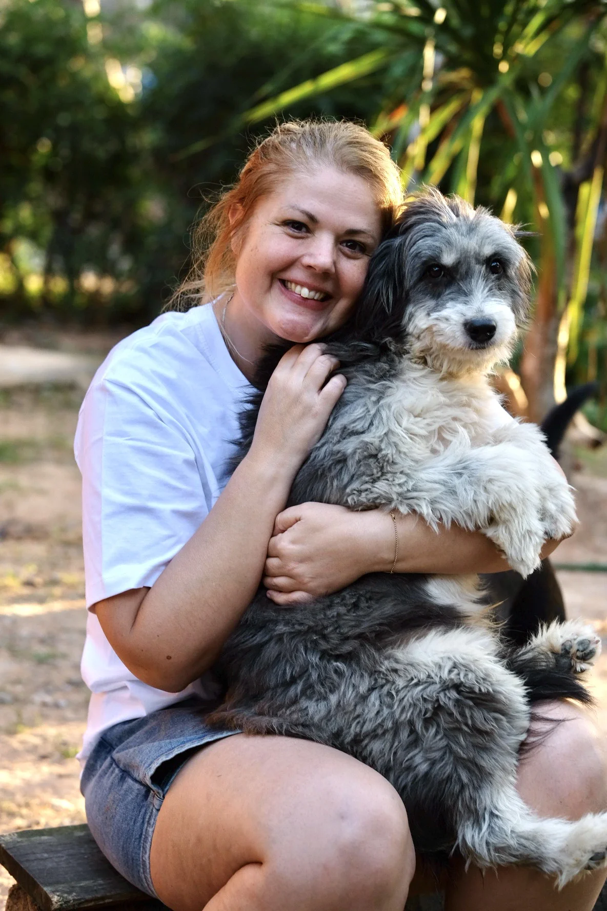 Volunteer hugging a rescued dog